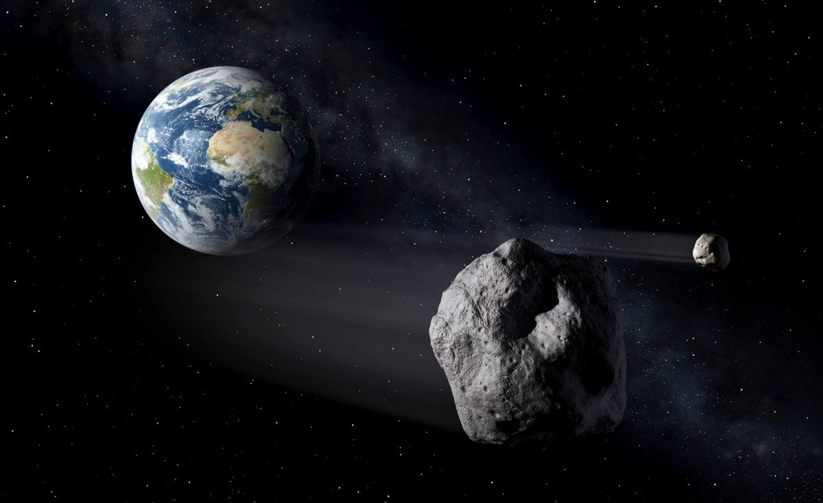 地球をかすめる小惑星を描いた想像図