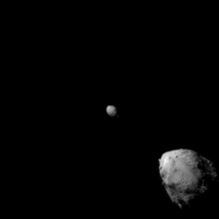【▲ NASAの探査機「DART」の光学カメラ「DRACO」で撮影された小惑星ディモルフォス（中央）と小惑星ディディモス（右下）。衝突の約2分半前、920km手前から撮影（Credit: NASA/Johns Hopkins APL）】